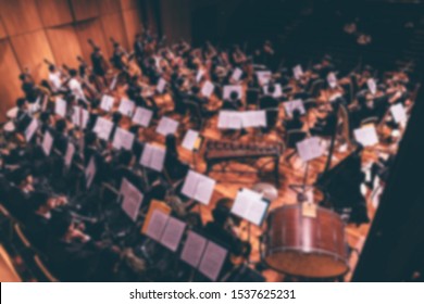 People playing music instruments inside a concert hall theme creative abstract blur background with bokeh effect