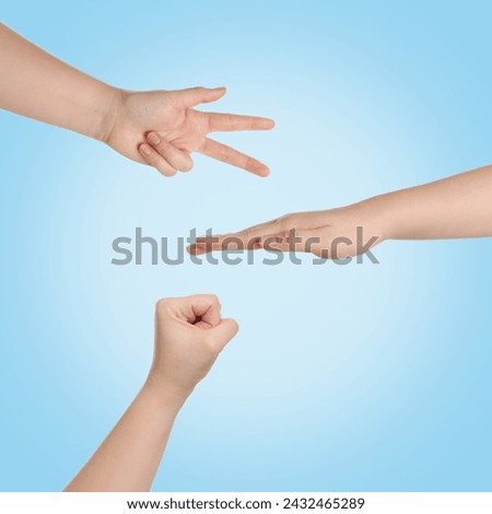 People playing rock, paper and scissors on light blue background, top view