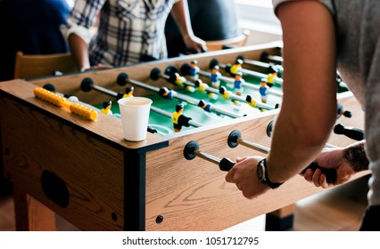 People playing table football - Powered by Shutterstock