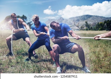 People playing tug of war during obstacle training course in boot camp - Powered by Shutterstock