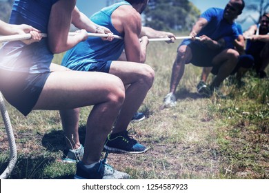 People playing tug of war during obstacle training course in boot camp - Powered by Shutterstock