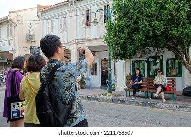 People Pose For A Photo On A City Centre Street In The Old Town On April 21, 2019 In George Town, Malaysia.