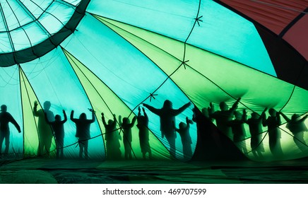 People Posing Through Hot Air Balloon