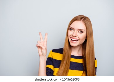 People positive funky dream dreamy rest relax weekend concept. Portrait of excited lovely beautiful with toothy beaming smile girl demonstrating two fingers isolated on gray background copy-space