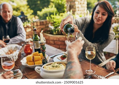 People, pour or hands with wine at thanksgiving dinner for celebration, family or holiday at table, Glass, champagne or serve alcohol in home for party or social gathering with beverage or drinks - Powered by Shutterstock