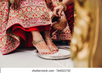 People pour water on Hindu bride's feet during the wedding ceremony Saptapadi