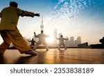 People practice taiji on the bund, oriental pearl tower in the distance,  in Shanghai, China