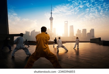 People practice taiji on the bund, oriental pearl tower in the distance,  in Shanghai, China - Powered by Shutterstock