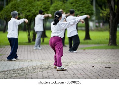 People Practising Tai Chi In The Park