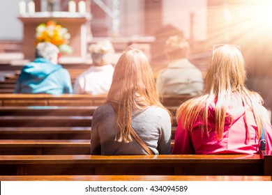 People praying in a church - Shutterstock ID 434094589