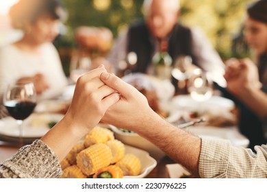 People, praying for eating and food for bonding, quality time for lunch and outdoor. Religious gesture, group and holding hands for brunch, family gathering and content for break, calm and peaceful. - Powered by Shutterstock