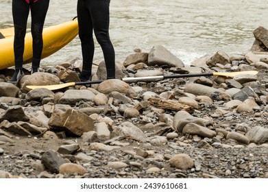 People prepare for rafting, mountain rafting for tourists. The athlete is waiting for the team on the bank of the river. - Powered by Shutterstock