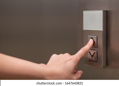 People Pressing The Button In The Lift And Select The First Floor By Using The Forefinger. Elevator Control Panel In Small Building Close Up. Bell Alphabet On The Button In The Passenger Lift.