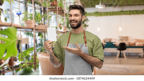 people, profession and job concept - happy smiling barman in apron with blank bill over restaurant background - Shutterstock ID 1874624449