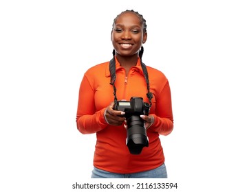 people, profession and photography concept - happy young woman with digital camera over white background
