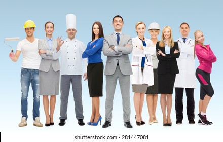 people, profession, qualification, employment and success concept - happy businessman with group of professional workers over blue background