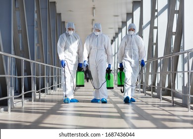 People in protective hazmat suits carrying barrels, pathogen respiratory quarantine coronavirus concept, copy space