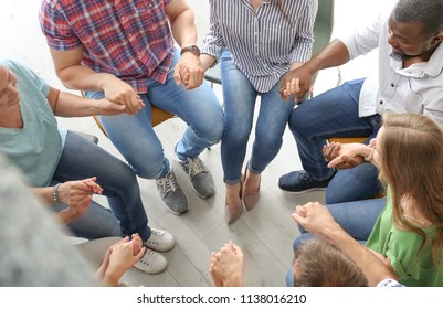 People putting hands together indoors. Unity concept