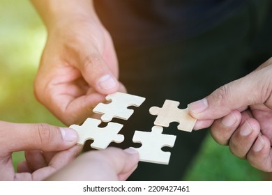 People putting the jigsaws team together.Charity, volunteer. Unity, team business. Concept of teamwork and partnership. - Shutterstock ID 2209427461