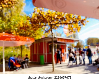 People Queue In Front Of An Ice Cream Kiosk, Blurred Scene