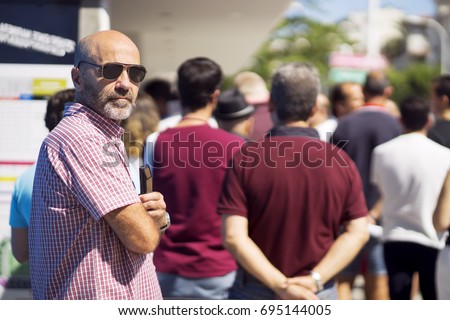 people  queue  in  line up ,  draggle
