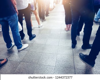 People In Queue Waiting For Something. Back Of Man And Woman Orderly In Line With Defocus