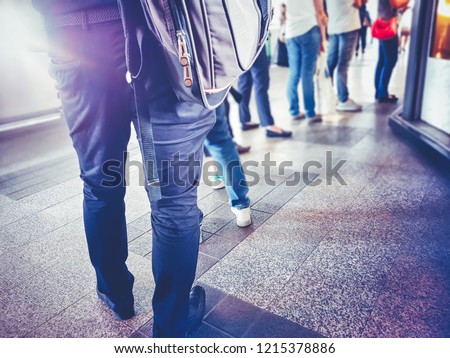 People in queue waiting for something. Back of man and woman Orderly in line with defocus