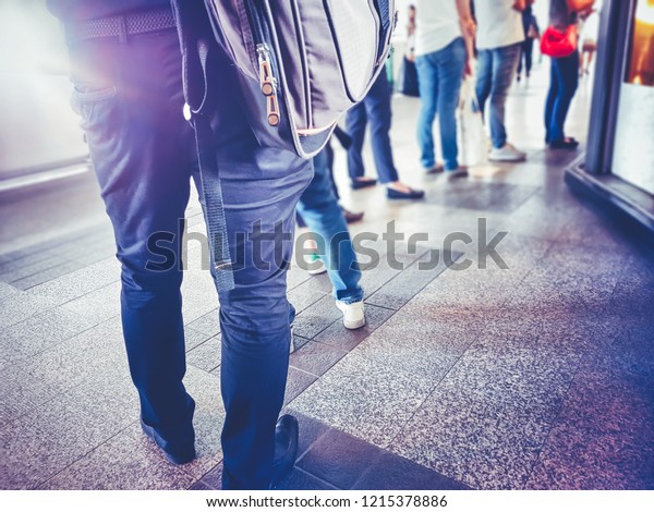 People in queue waiting for something.\
Back of man and woman Orderly in line with\
defocus