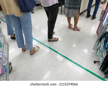 People Queuing To Pay For Goods In A Supermarket