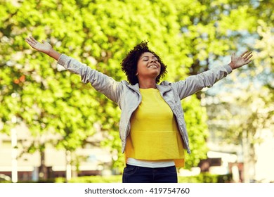 People, Race, Ethnicity And Portrait Concept - Happy African American Young Woman With Open Arms In Summer Park