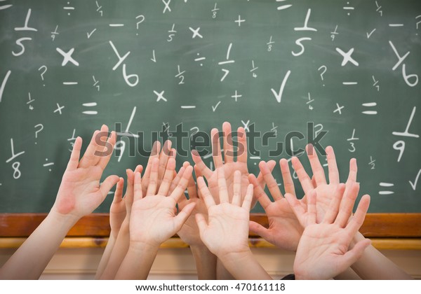 People\
raising hands in the air against\
blackboard