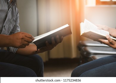 People Reading The Holy Bible. Man And Woman Reading A Book. Teacher And Student Reading Together.