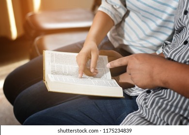 People Reading The Holy Bible. Man And Woman Reading A Book. Teacher And Student Reading Together.