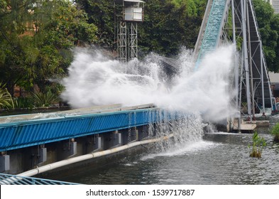 People Really Enjoy The Holiday In Dunia Fantasi Ancol, Jakarta Theme Park. Big Water Splash From Roller Coaster That Run So Fast. 