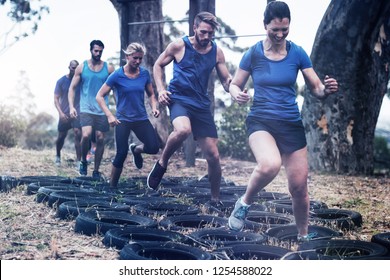 People receiving tire obstacle course training in boot camp - Powered by Shutterstock