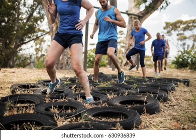 People receiving tire obstacle course training in boot camp - Powered by Shutterstock