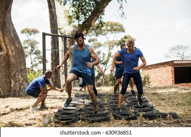 People receiving tire obstacle course training in boot camp - Powered by Shutterstock