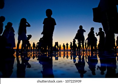 People Reflections On Colorful Sunset In Zadar, Croatia