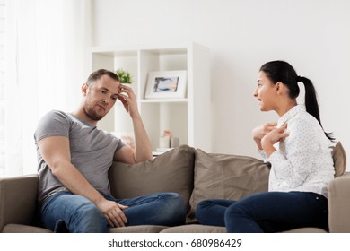 People, Relationship Difficulties, Conflict And Family Concept - Unhappy Couple Having Argument At Home