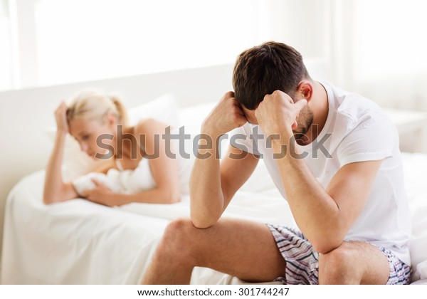 people, relationship\
difficulties, conflict and family concept - unhappy couple having\
problems at bedroom