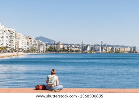 People relaxing along the bay of the Aegean Sea with white tower view in the center of Thessaloniki in Central Macedonia in Greece