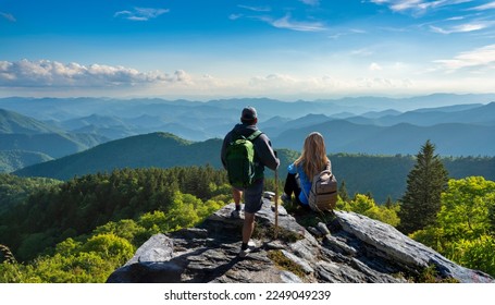 People relaxing on hiking trip. Couple on top of the mountain enjoying beautiful view. Blue Ridge Mountains, near Asheville, North Carolina.USA. - Powered by Shutterstock