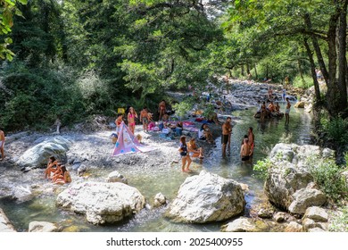People relaxing on a summer day at the Peschiera Torrent in the Magnano Woods in Chiaromonte, Potenza, Basilicata, Italy - 15.08.2021