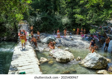 People relaxing on a summer day at the Peschiera Torrent in the Magnano Woods in Chiaromonte, Potenza, Basilicata, Italy - 15.08.2021