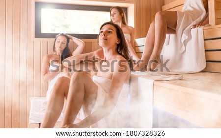 People relaxing in the sauna female friendship and spa treatment