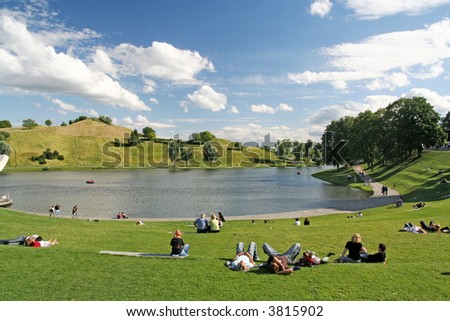 People relaxing and strolling in the Olympic park of Munich