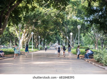 People relaxing and walking through Hyde Park in Sydney,Australia/Exploring Hyde Park/SYDNEY,WA,AUSTRALIA-NOVEMBER 18,2016: People walking and resting at Hyde Park in downtown Sydney, Australia