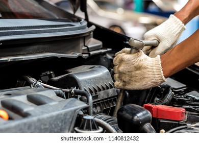 People are repair a car Use a wrench and a screwdriver to work. - Shutterstock ID 1140812432