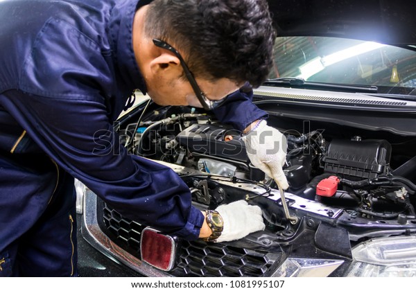 People are\
repair a car Use a wrench and a screwdriver to work.Regular car\
care makes car use. Safe and confident in driving. Regular\
inspection of used cars. It is very well\
done.