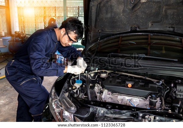 People are repair a car Use a wrench and a\
screwdriver to work.Safe and confident in driving. Regular\
inspection of used cars. It is very well\
done.